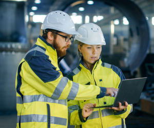 Construction workers looking at a laptop